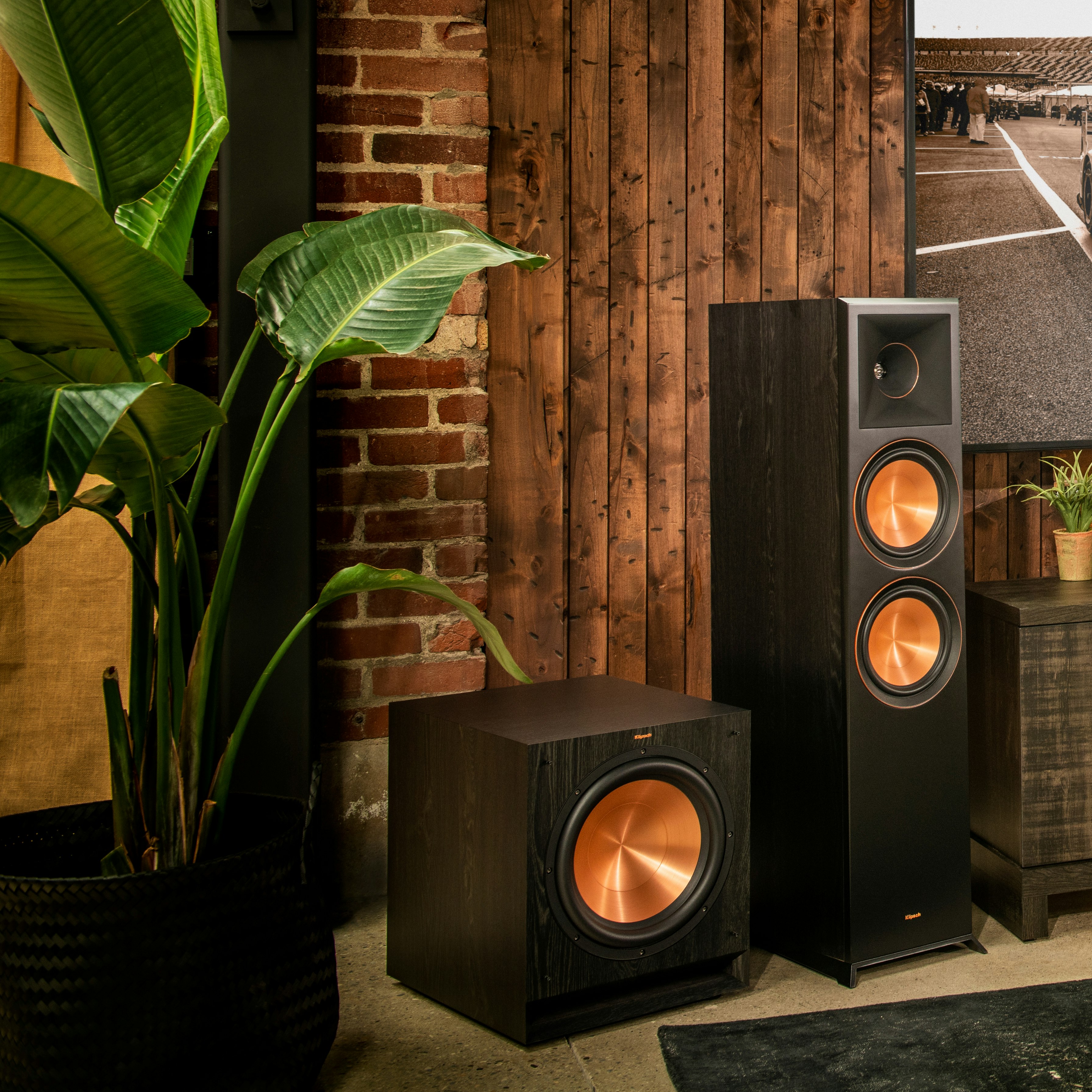 SPL-120 subwoofer and floorstanding speaker next to a tv